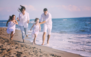 happy young  family have fun on beach